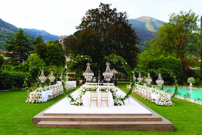The bride and groom's al fresco wedding reception is set amidst the Italian mountains. 
