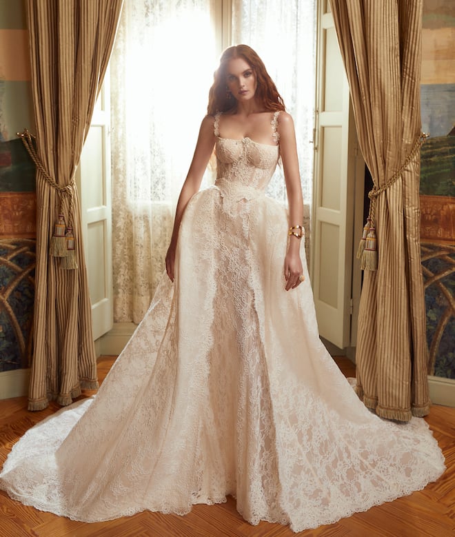 An all-lace sleeveless wedding gown with a basque waist. 