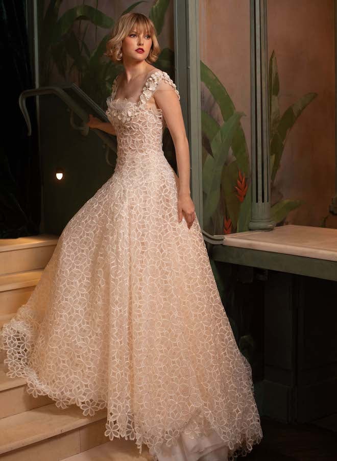 A sleeveless a-line bridal gown with a textured skirt. 