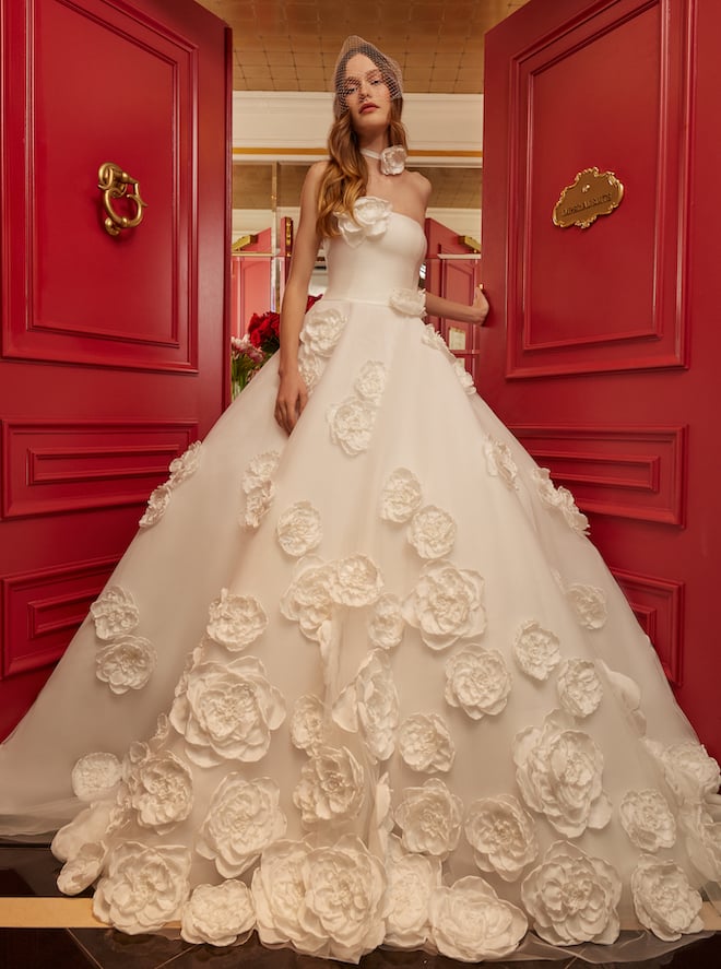 Model wearing an organza Floral Applique oversized ballgown with Italian Stretch Mikado bodice and hand placed floral details.