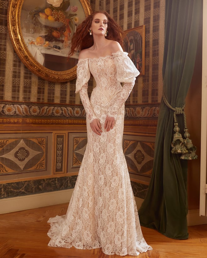 An all-lace mermaid gown with off-the shoulder puffy lace sleeves. 