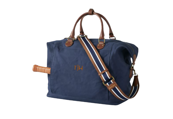 Navy canvas pickeball bag with brown handles and monogram. 