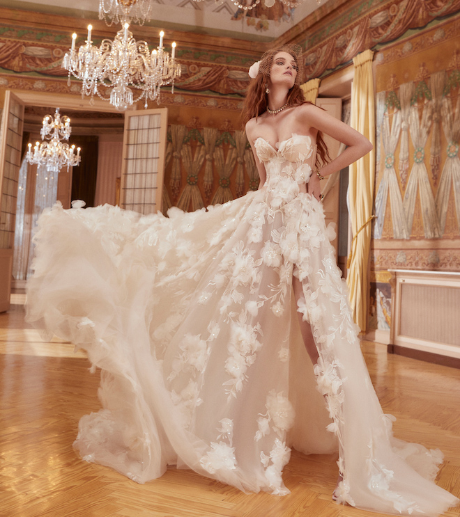 A strapless wedding gown with floral embellishments and a tulle skirt. 