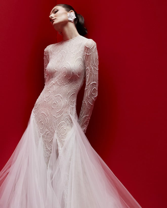 A fitted long-sleeve textured mermaid gown with a tulle skirt. 