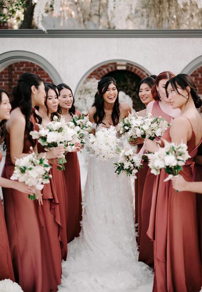 The bride and her bridesmaids pose for a candid photo at the wedding ceremony.