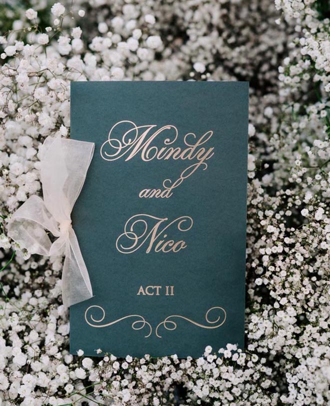 Green wedding stationery with the bride and groom's name on it "Mindy and Nico."