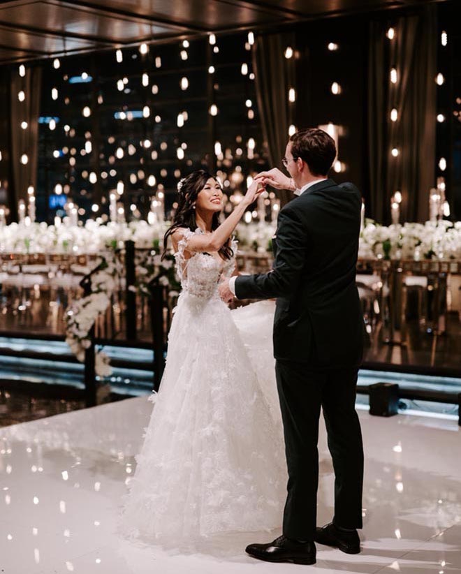 The bride and groom dance at their Broadway-styled wedding reception.