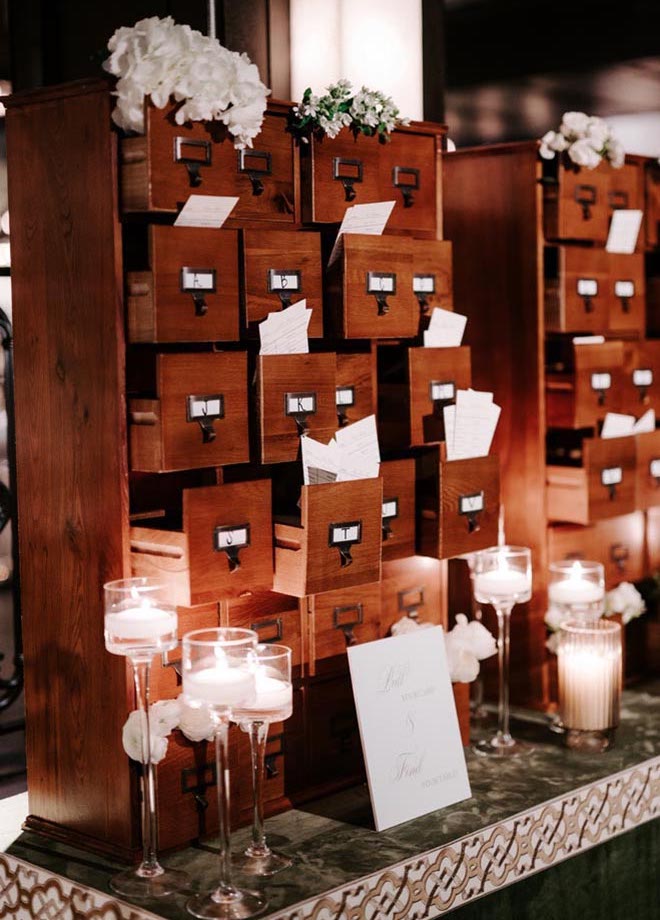 Wooden filing cabinets serve as seating charts at the Broadway-styled reception at The Astorian.