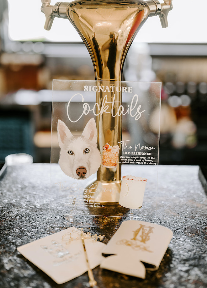 An acrylic signature cocktail menu with a husky's face next to "The Norman" cocktail. 