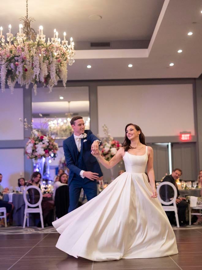 The bride and groom share their first dance on the dance floor in the Omni Houston Hotel's ballroom.