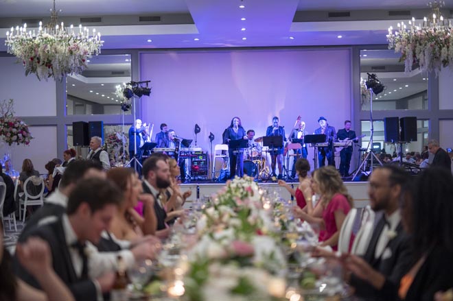 Live music and entertainment perform while wedding guests eat their dinner. 