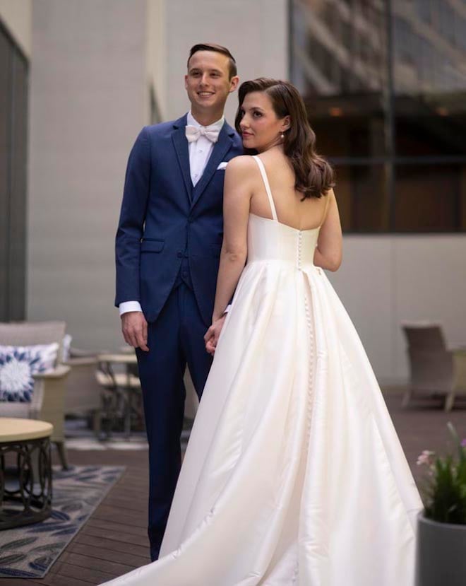 The bride and groom wed with a pink and navy ballroom wedding in Houston. 