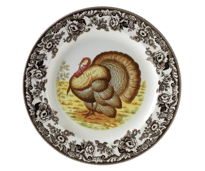 Brown flowers on the rim of the plate with a turkey in the middle.