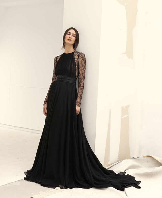 The model wears a black down with lace sleeves by Soucy.