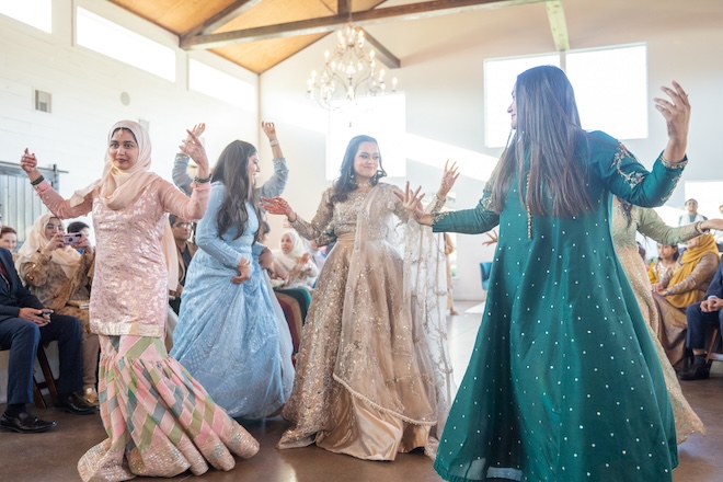 The bride and other women performing a dance at the reception.