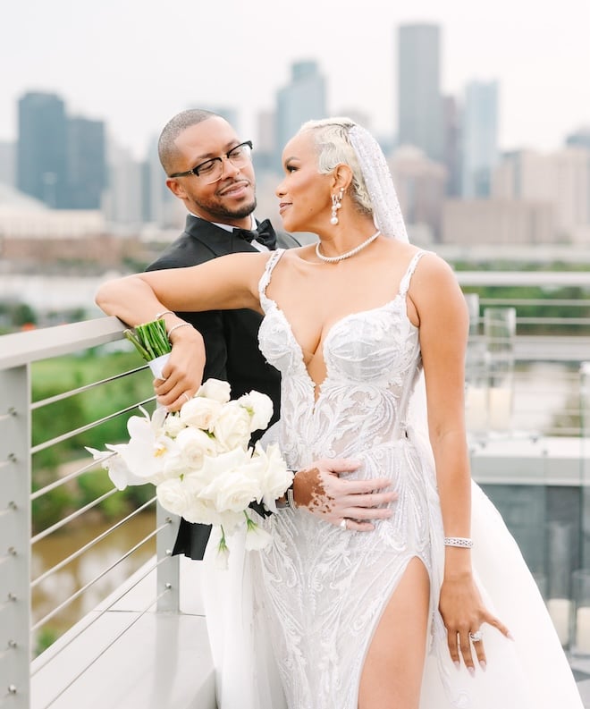 LeToya Luckett smiling at her groom with the Houston skyline in the background.