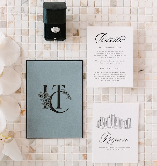 The stationery with the Houston Skyline on the invitation and a blue and black monogram on the front.