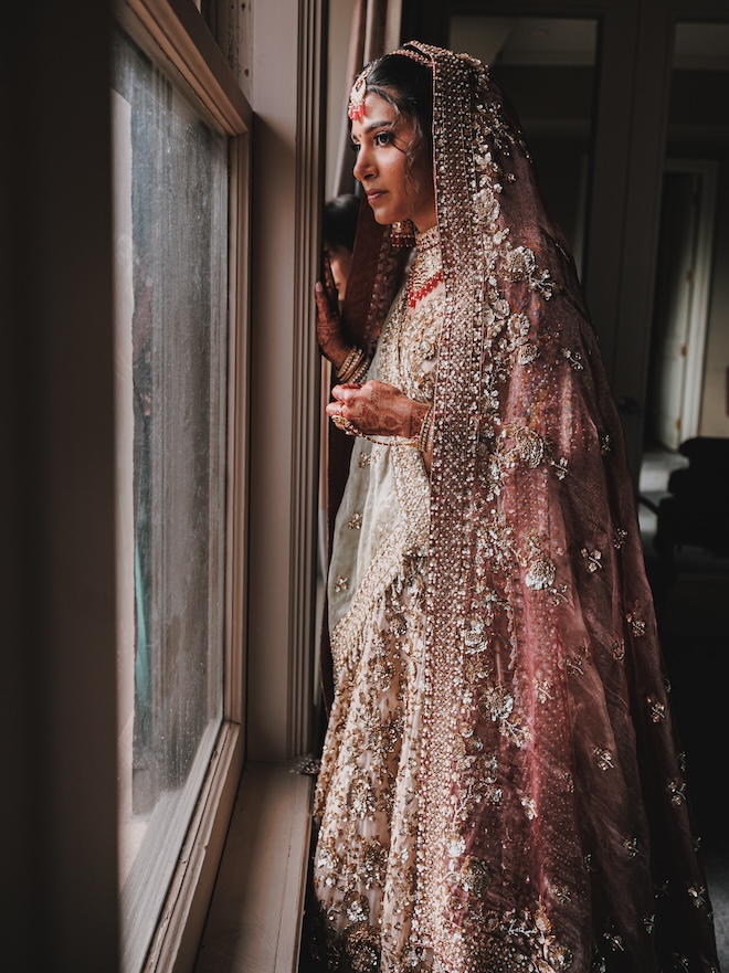 The bride looking out a window.