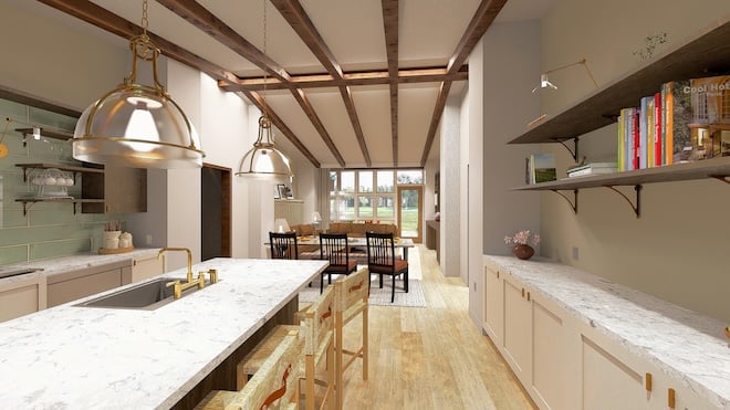 A kitchen in a private villa with marble countertops, wooden beam ceilings and a dining table overlooking the grounds.
