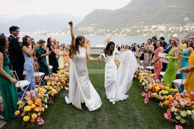 The brides dancing back down the aisle.