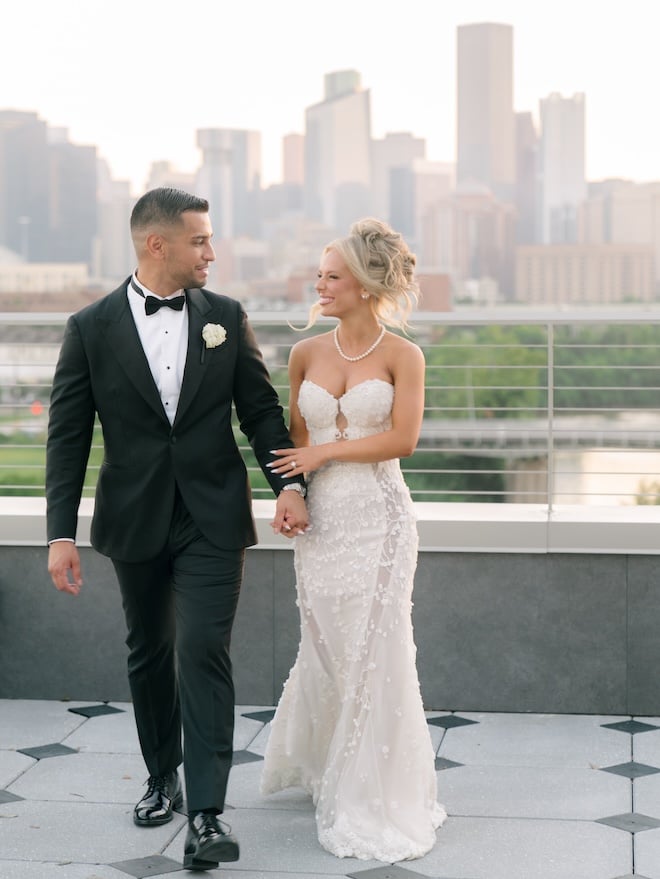 A bride and groom smiling at each other on the terrace at Le Tesserae.