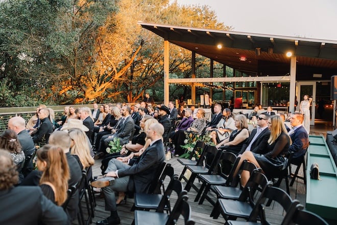 Guests sitting for a wedding ceremony on the second floor of The Grove.