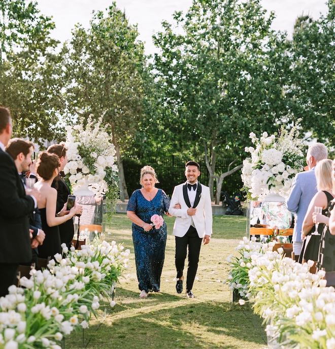 Ben walking down the aisle with his mother. 