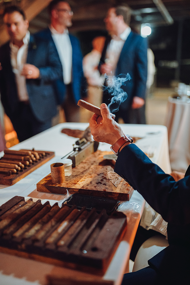 The couple have a custom cigar station at their wedding reception for guests to indulge in creating their own cigar.