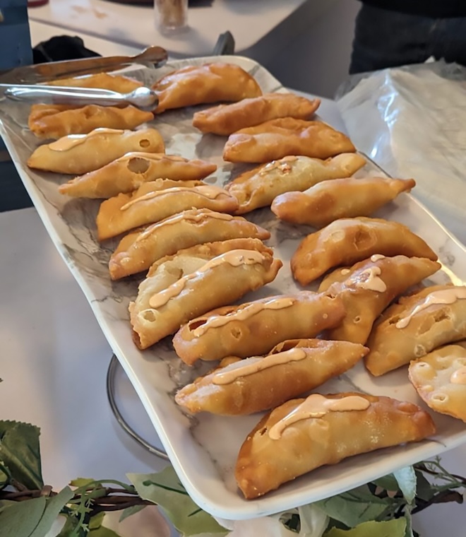 Dumplings with spicy mayo on top.