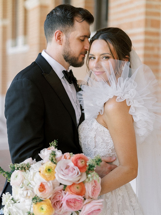 The bride and groom wed in a soft pastel wedding in Houston.