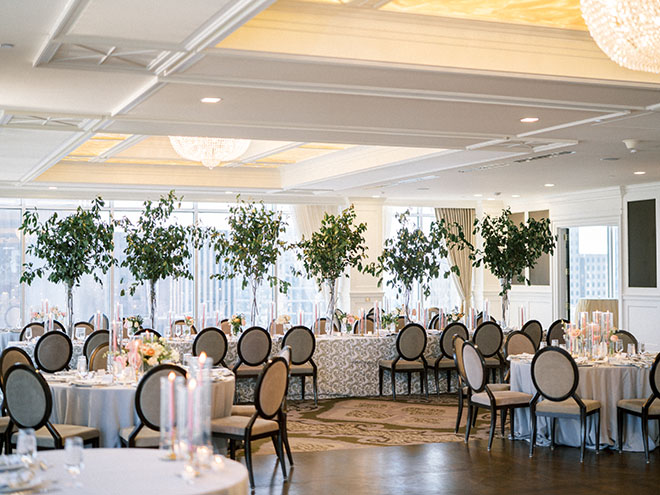 Greenery, pink candles and bud vases decorate the ballroom at the Petroleum Club of Houston.