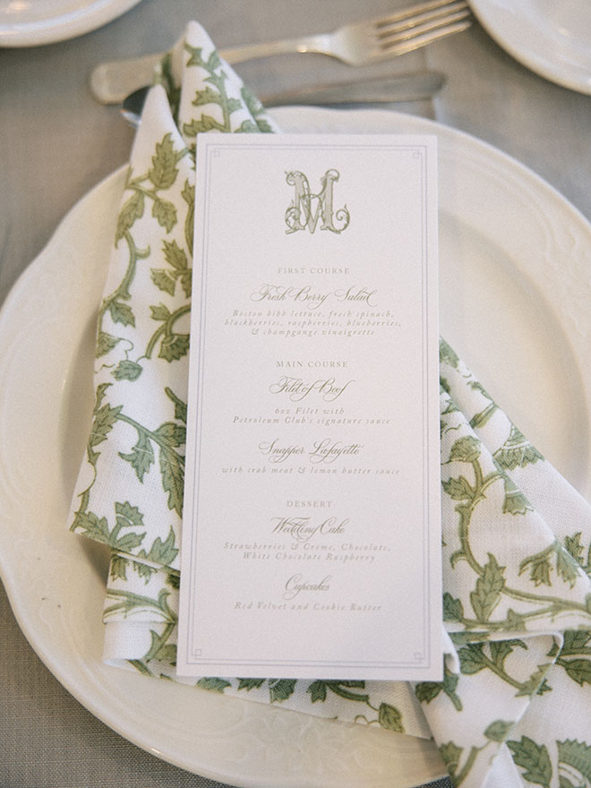 Green printed napkins and menus are set on the reception tables in Houston.