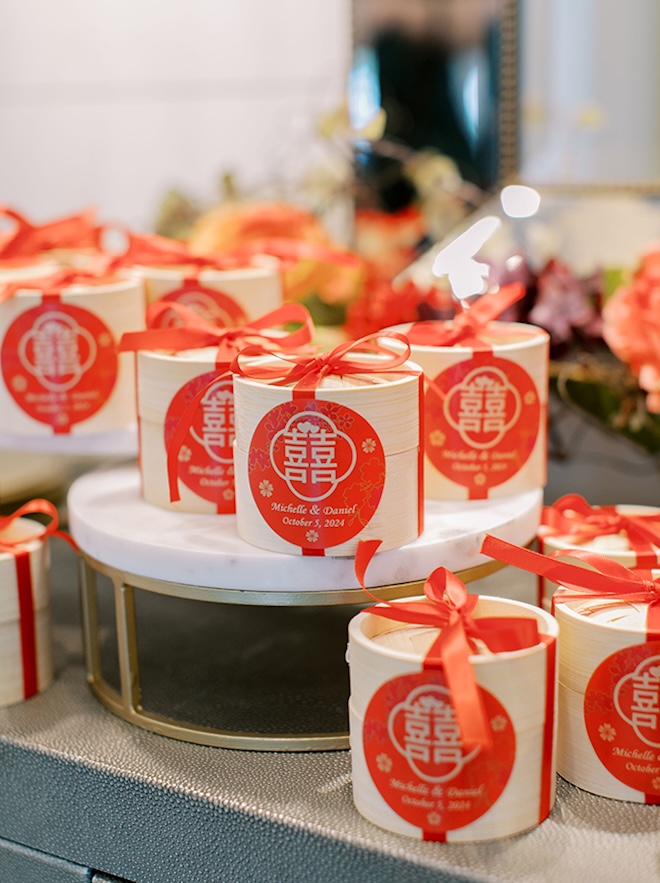 The couple has red steam basket favors for guests as their wedding favors.