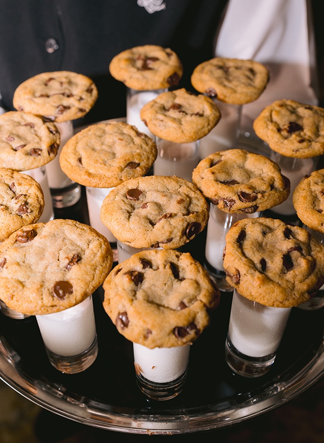 Milk and cookies are passed around during the wedding reception on a silver platter as a late night snack for guests.