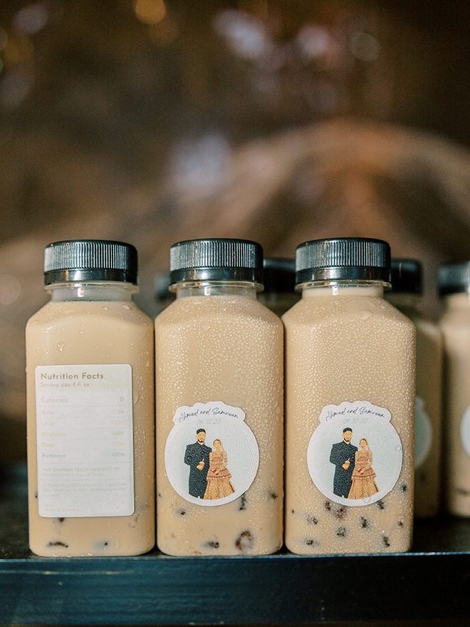 Boba tea with personalized stickers of the bride and groom are wedding favors.