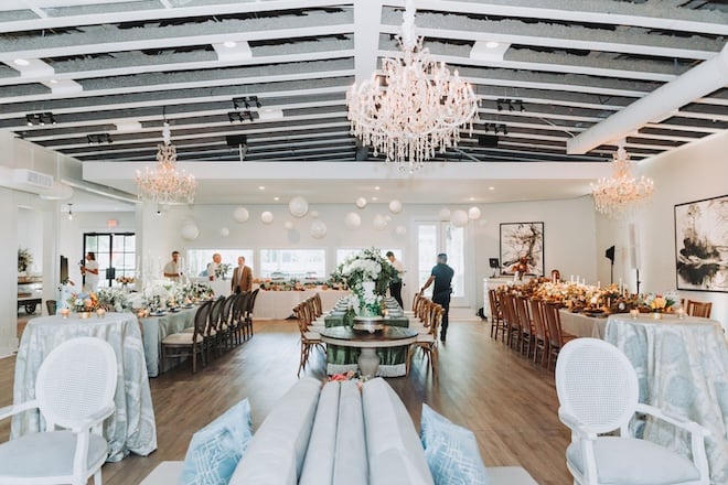 The White House is an event space with white walls, hard wood floors and chandeliers.