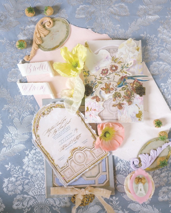 An invitation suite featuring florals, blue pink and gold hues.