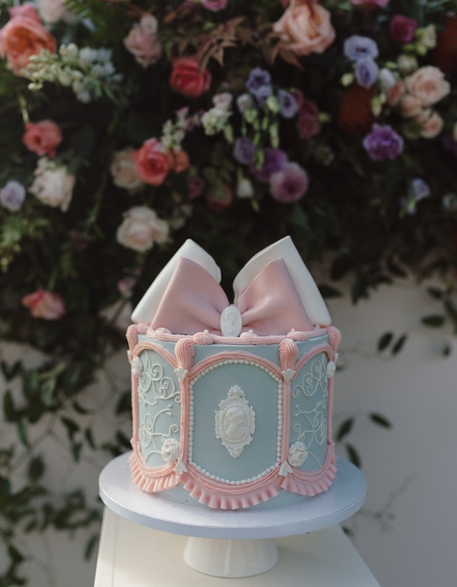 A Bridgerton-inspired cake with pink, white and blue frosting.
