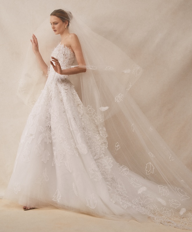 A strapless floral-inspired wedding gown and veil by Oscar de la Renta.
