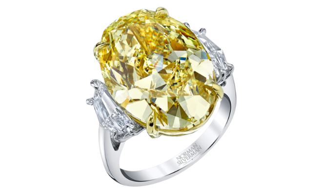 A yellow diamond engagement ring with a a silver band from Deutsch Fine Jewelry. 