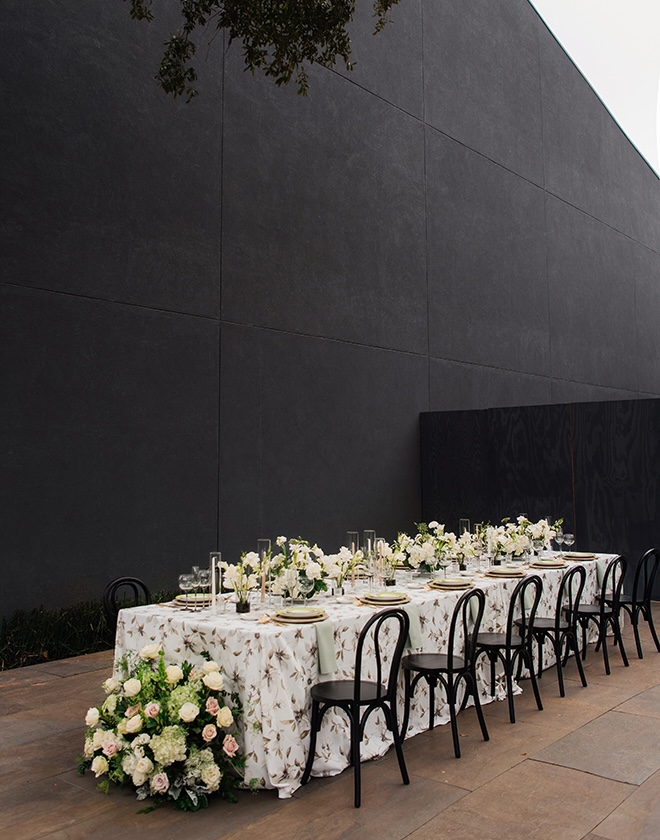 Pastels and greenery decorate the family style reception tables in the courtyard. 