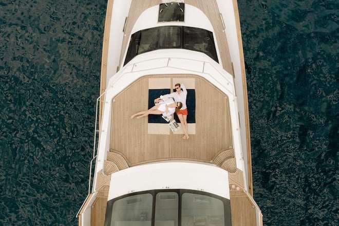 A couple lounging on a boat deck. 