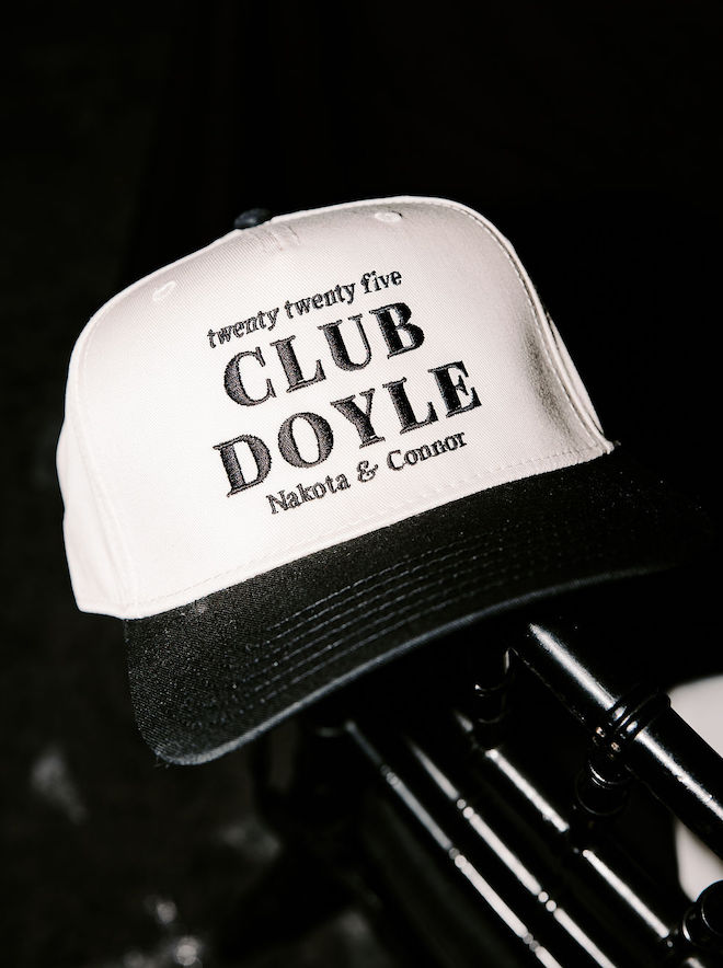 Baseball hat for reception guests that reads, "Twenty twenty five, Club Doyle, Nakota & Connor"