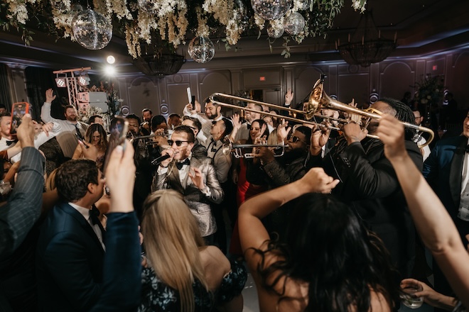 Danny Ray and the Atlantic Street Band perform on the dance floor with wedding guests in the ballroom of The Houstonian Hotel, Club and Spa. 