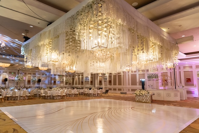 The ballroom of Houston Marriott Sugar Land decorated with a white floral canopy. 