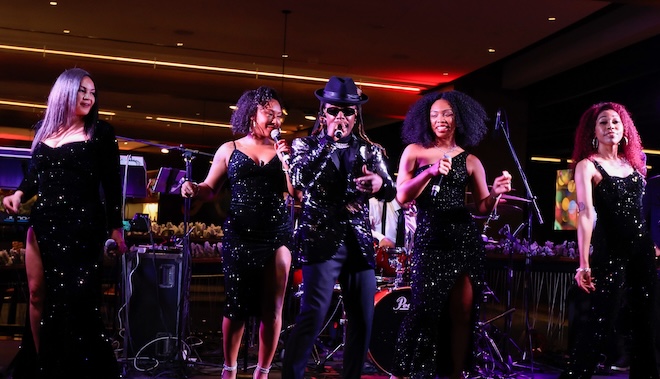 Royal X Band performs on the stage for wedding guests. 