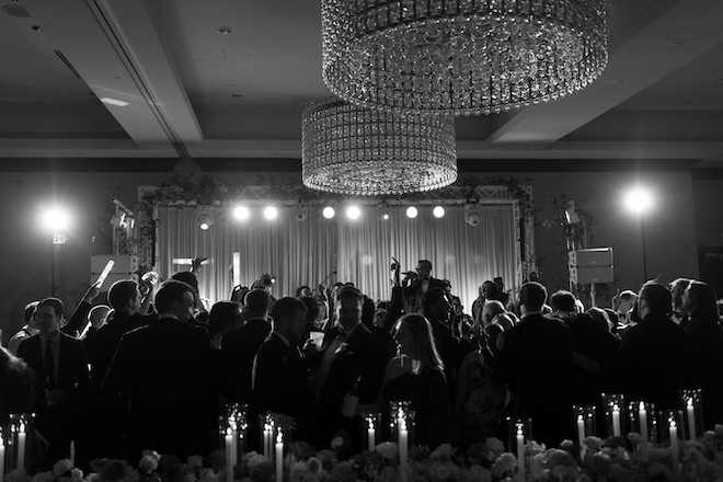 Black and white photo of the band playing and guests dancing on the dance floor.
