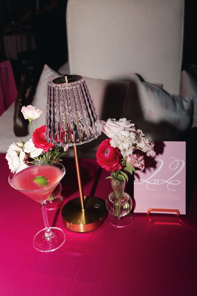 Pink wedding party table 22 setting with a pink cosmo cocktail with pink and white flowers.