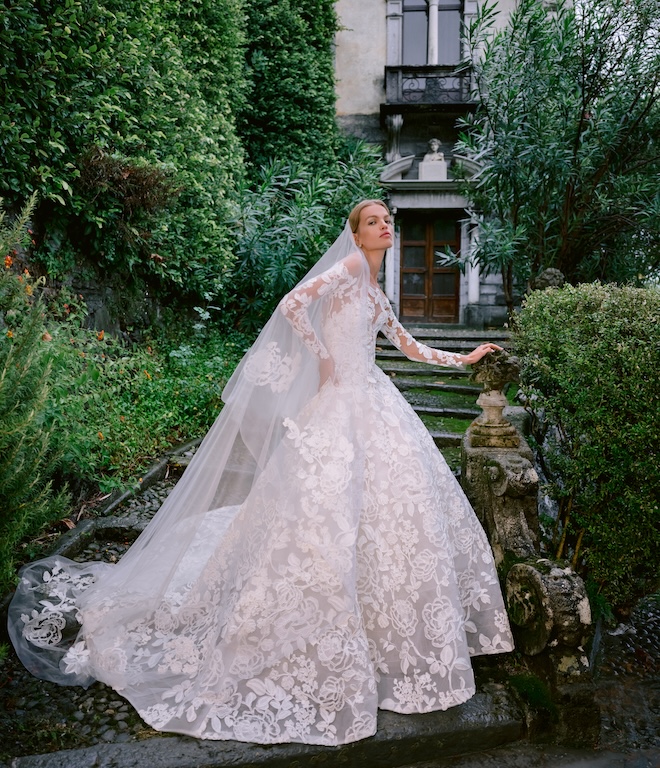 A model wearing a lace long-sleeve wedding gown by Monique Lhuillier. 