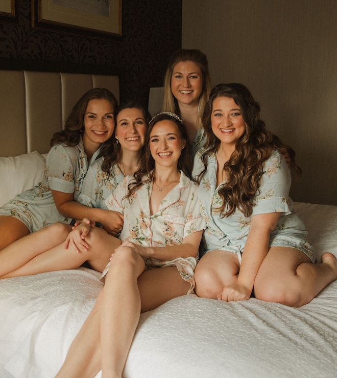 The bride and her bridesmaids wearing floral pajamas. 